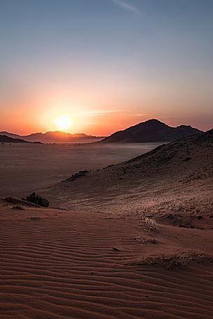 Sunset from the Tiras Mountains with scenic view on the valley below in Kanaan Desert Retreat, border of Namib Desert, Namibia, Africa