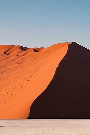 Orange desert dune lateral view at sunrise, Namib Naukluft National Park, Sesriem, Namibia, Africa