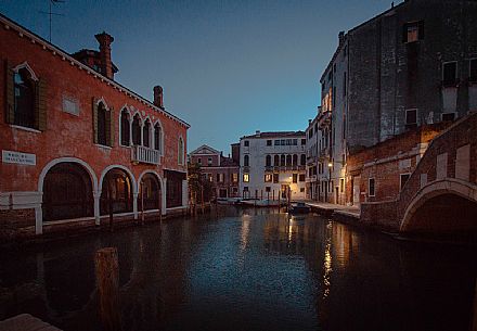 Dusk view on a typical venetian canal with Venice, Veneto, Italy, Europe