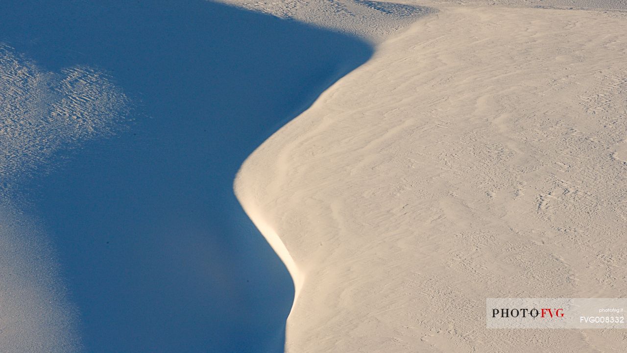 Lights and shadows chasing each other in the highlands covered with snow