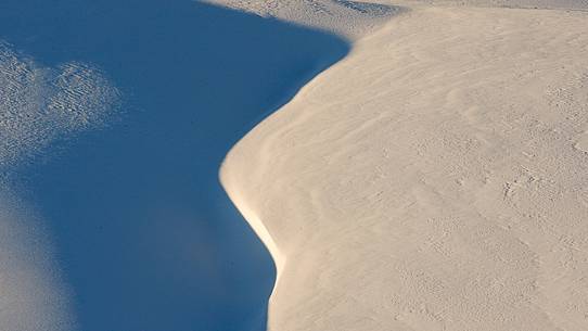 Lights and shadows chasing each other in the highlands covered with snow