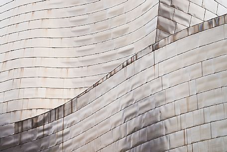 Details of Guggenheim museum in Bilbao. With its interesting color and texture of the walls, great is the contrast between the sharp edges and curved surfaces, Bilbao, Spain