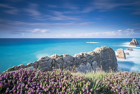 A silky vision of the Bajos de Arnia in Cantabria in the late afternoon, between a ray of light and some showers, waiting for sunset, Spain