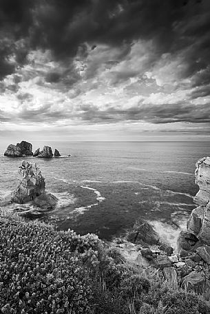 A cloudy and dynamic view of the magical cliffs on the Atlantic Ocean at the Bajos de Arnia in Cantabria, Spain
