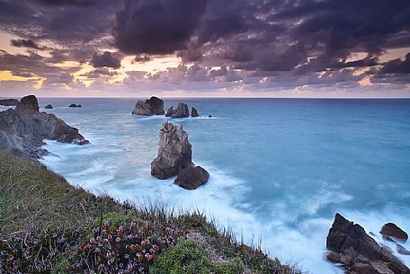 A dynamic sunset on the magical cliffs on the Atlantic Ocean at the Bajos de Arnia in Cantabria, Spain, Europe
