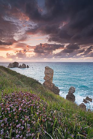 A dynamic sunset on the magical cliffs on the Atlantic Ocean at the Bajos de Arnia in Cantabria, Spain, Europe