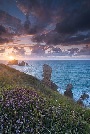 A dynamic sunset on the magical cliffs on the Atlantic Ocean at the Bajos de Arnia in Cantabria, Spain, Europe