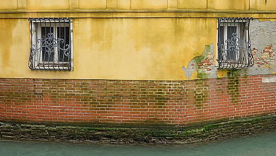 Detail of house and typical canal in Venice, Italy, Europe