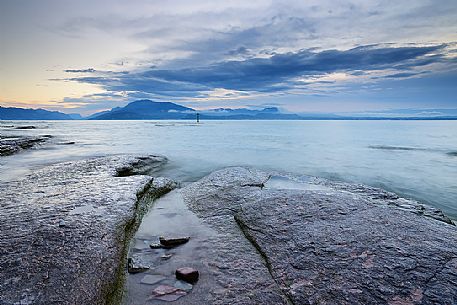 Garda lake from Sirmione coast, in the background the Monte Baldo mount and the Mount Pastello, Brescia, Lombardy, Italy, Europe