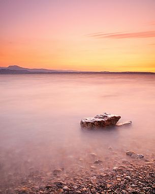 Garda Lake at sunrise from Sirmione, in the background the Mount Pastello in silhouette, Brescia, Lombardy, Italy, Europe