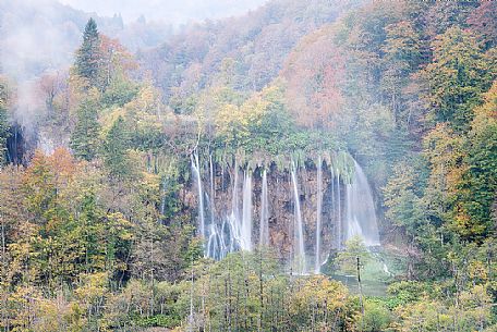 A vision of a waterfall in the colorful autumn forest in the Plitvice national park, Dalmatia, Croatia, Europe