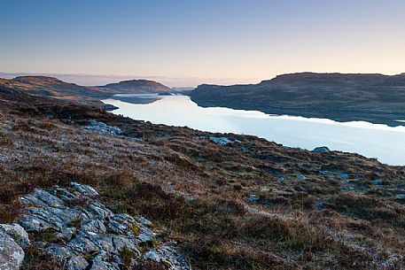 Dawn over frost covered meadows looking out over the waters of Loch Rog Beag near Giosla in the Outer Hebrides on the Isle of Harris, Scotland.