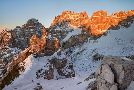 Warm colors of sunrise on Monfalconi di Forni mountain chain
