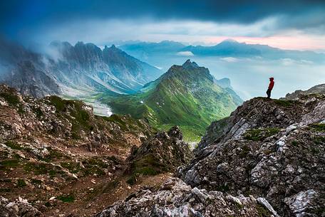 An hiker admires the amazing view over Passo di Suola.