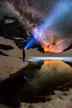 Adventure in the mountain at night, with visible Milky Way in the background