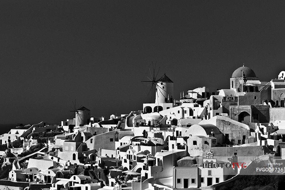 windmill on santorini island on sunset