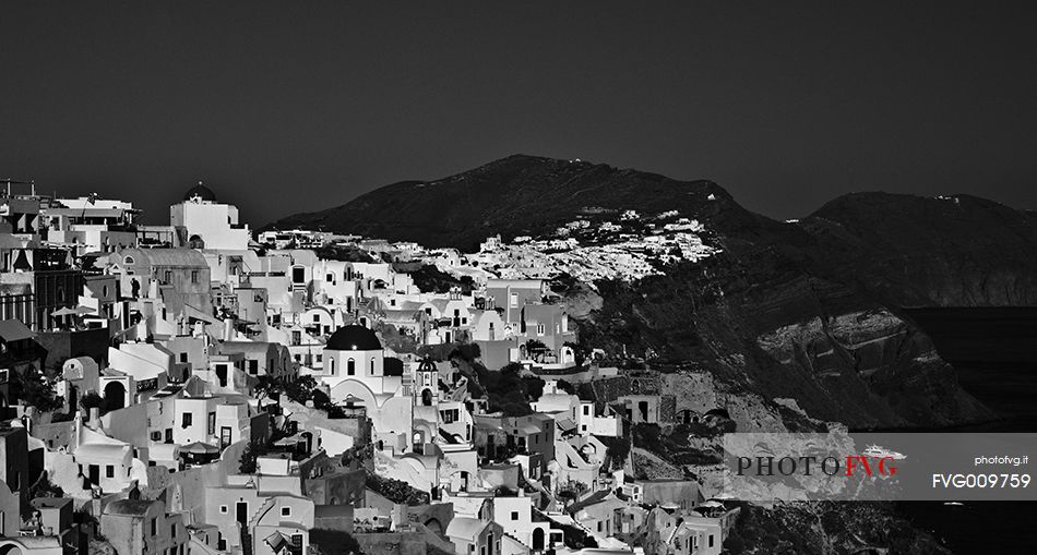 windmill on santorini island on sunset