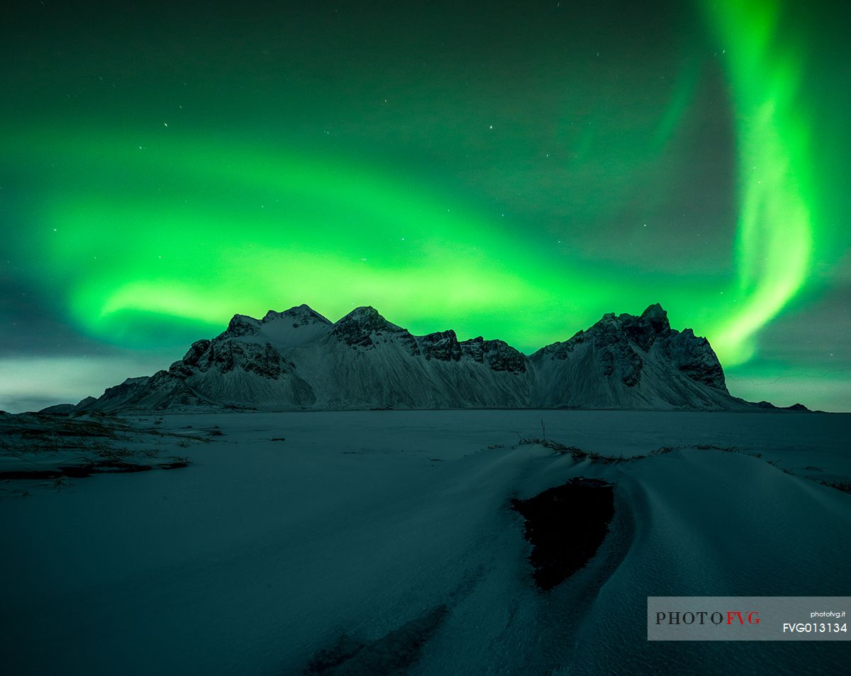 Northern lights over the black beach of Stokksens