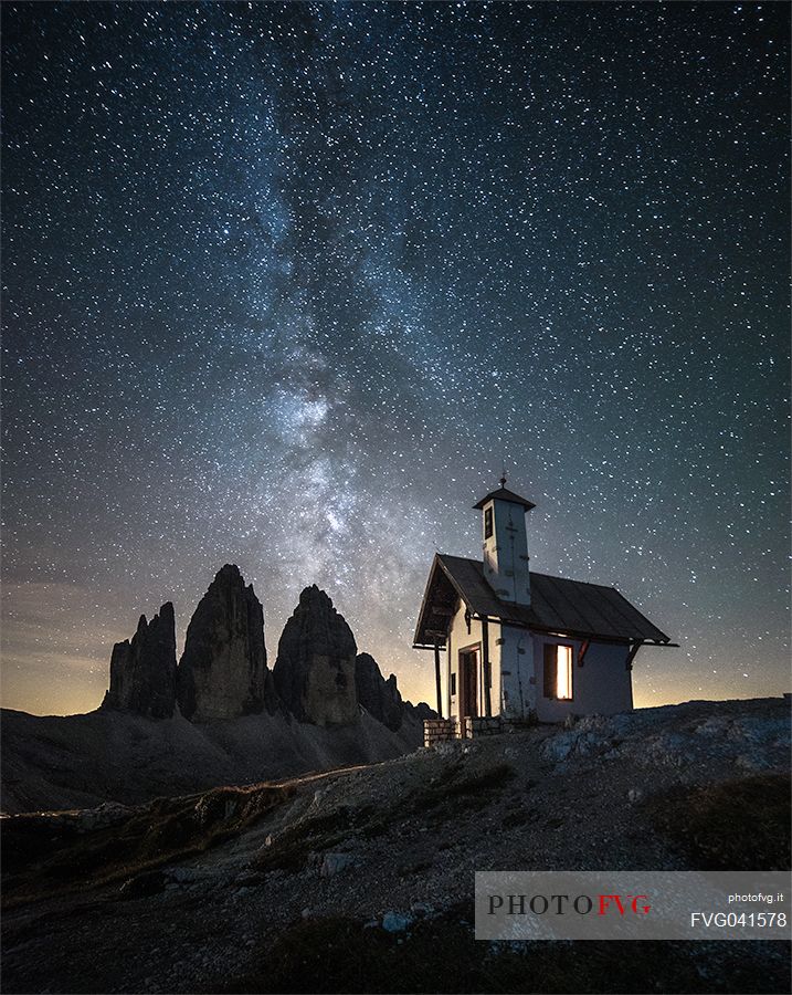 Milkyway over Tre Cime di Lavaredo peak and the small chapel, dolomites, Sexten, South Tyrol, Europe
