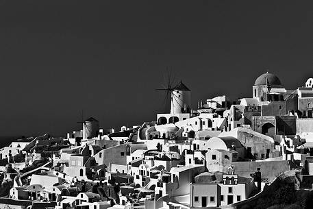 windmill on santorini island on sunset