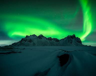 Northern lights over the black beach of Stokksens