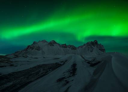 Northern lights over the black beach of Stokksens