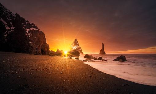 The black sand beach of Reynisfjara and the mount Reynisfjall from the Dyrholaey promontory in the southern coast of Iceland, Vik