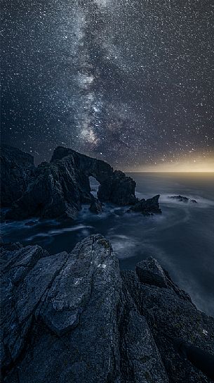 Iconic scottish landscape, sea arch whit milky way, Luskentyre, Harris isle, Hebrides, Scotland, UK