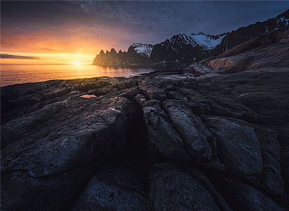 View from Tungeneset viewpoint towards Okshornan Mountains with Devil's Teeth at sunset, Senja Island, Norway