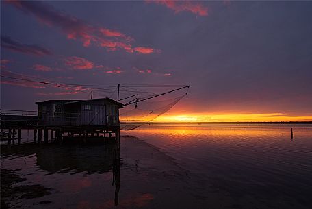 Typical fishing house in the adriatic coast at sunset, Marina di Ravenna, Emilia Romagna, Italy, Europe