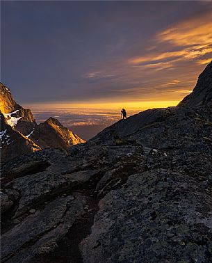 Photographer takes a picture of wild landscape near Reine village, Moskenesoy, Lofoten Islands, Scandinavia, Norway, Europe