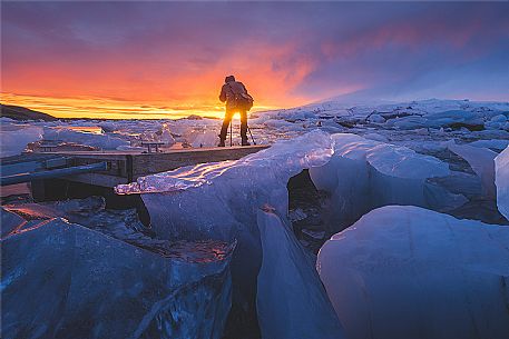 Photographer at Jokulsarlon lagoon at sunset, South Iceland, Iceland, Europe