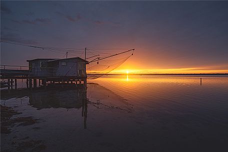 Typical fishing house in the adriatic coast at sunset, Marina di Ravenna, Emilia Romagna, Italy, Europe