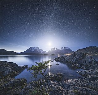 milky way and the moon over torres del paine from lake Pehoe, Patagonia, Chile