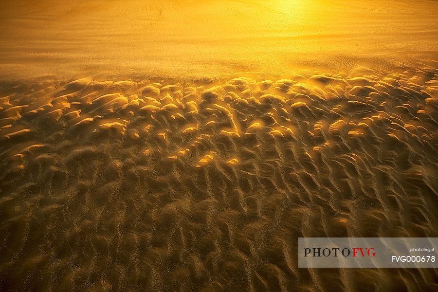 The gold sand of the beach in front of Bamburgh castle