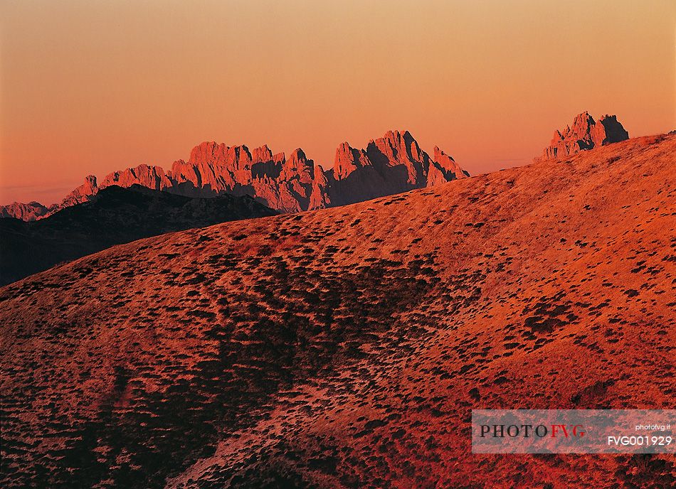 The early autumn lights set the Dolomites' Friulane sides and peaks on fire