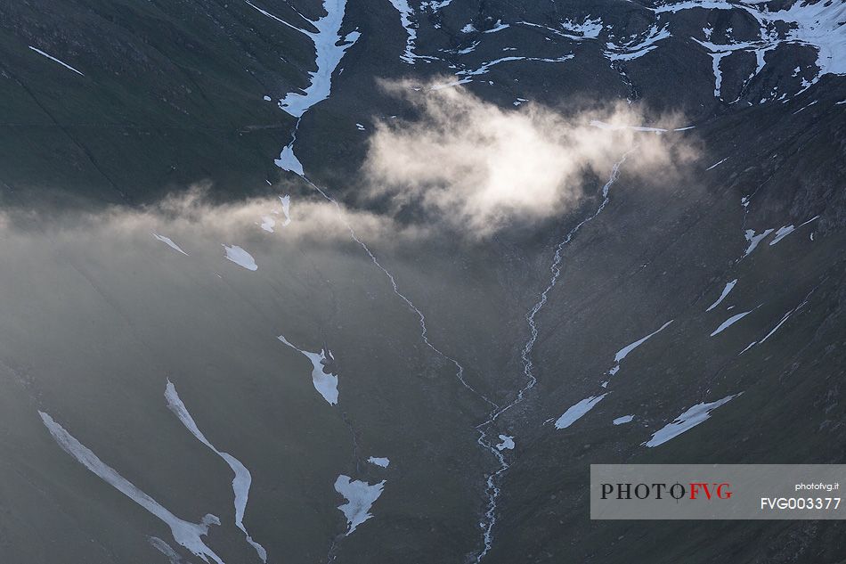 Detail of source of Rhone river near Furka pass at dawn, Valais, Switzerland, Europe