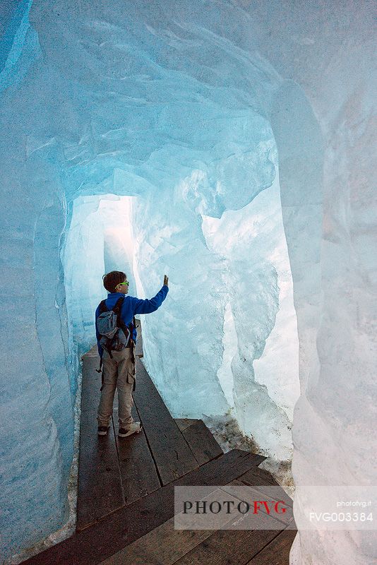 Child inside the Rhone glacier, Furka pass, Valais, Switzerland, Europe