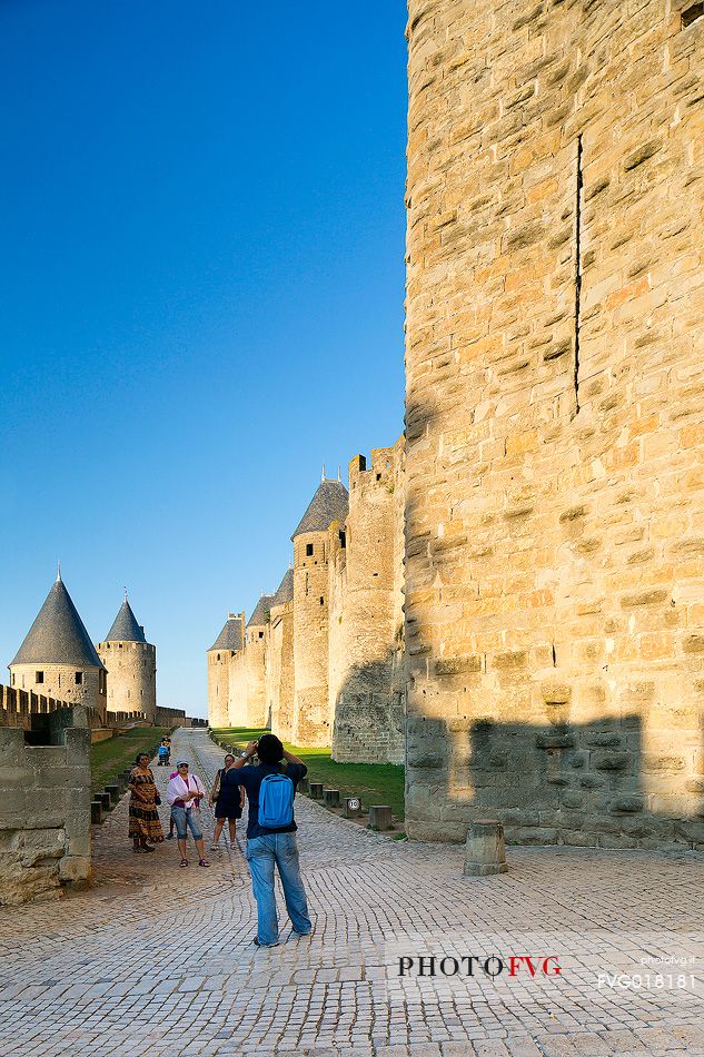 Tourists visiting the mediavel ancient city of Carcassonne at morning