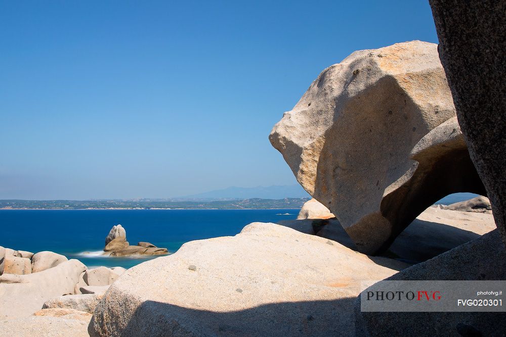 Stones in Lavezzi islands in natual reserve of Bocche di Bonifacio and in the background the island of Corsica