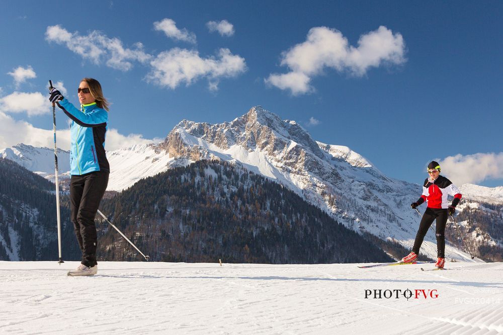 Cross-country skiing on the slopes of Sauris di Sopra , in the background the Monte Bivera , Sauris