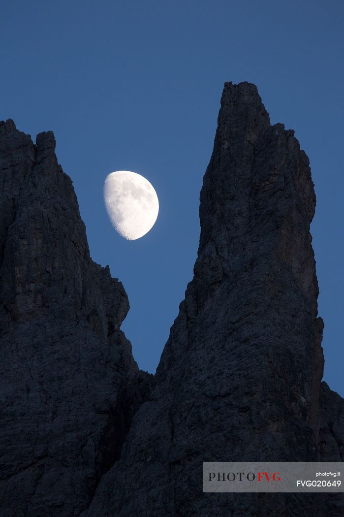 The moon rises on the Popera spiers in the Sesto Dolomites, from Berti refuge, Cadore, dolomites, Italy