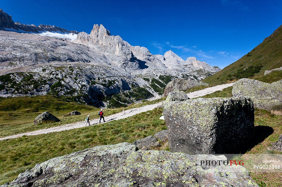 Hiking along the path of Padon Hut, Marmolada in the background, Dolomites, Italy
 