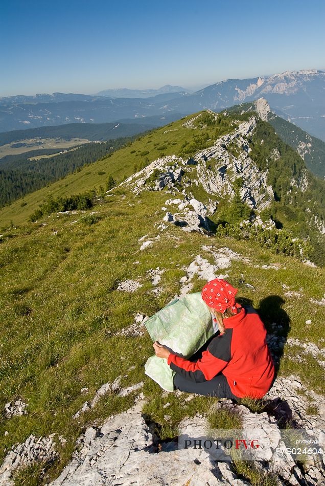 Hiker on the top of mount Manderiolo, Asiago, Italy