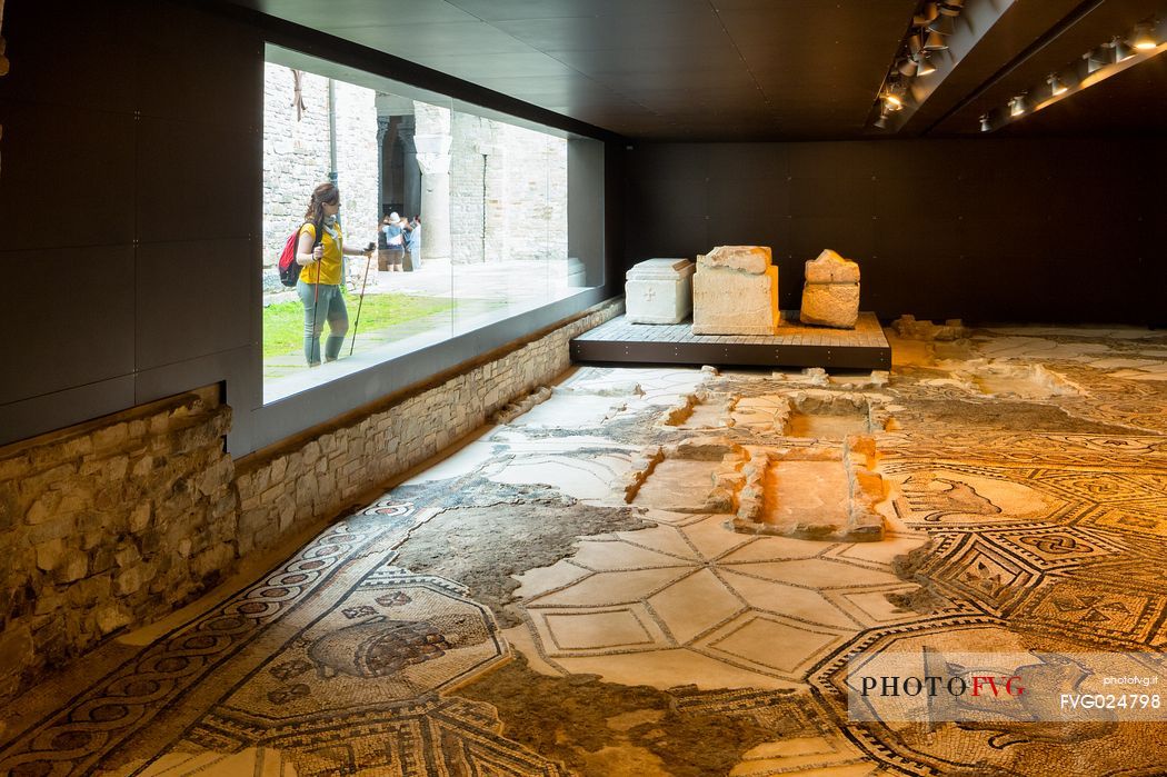 tourist to South Halle admire the ancient remains of the mosaics of Aquileia basilica, Italy