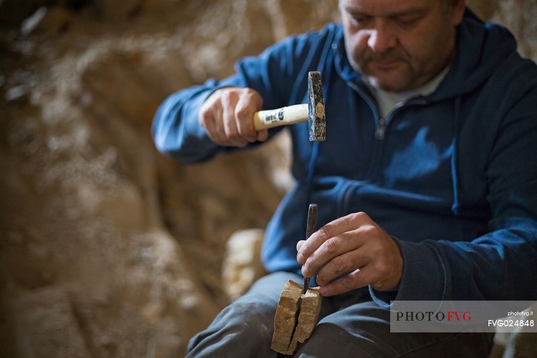 Massimo Cerato is working in the fossil bed of Pesciara in Bolca, Lessini mountain, Italy