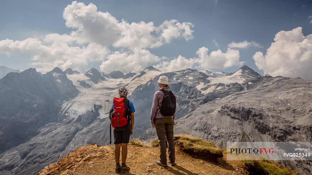Hikers near Passo dello Stelvio pass and in the background the Stelvio glacier, Passo dello Stelvio national park, Italy