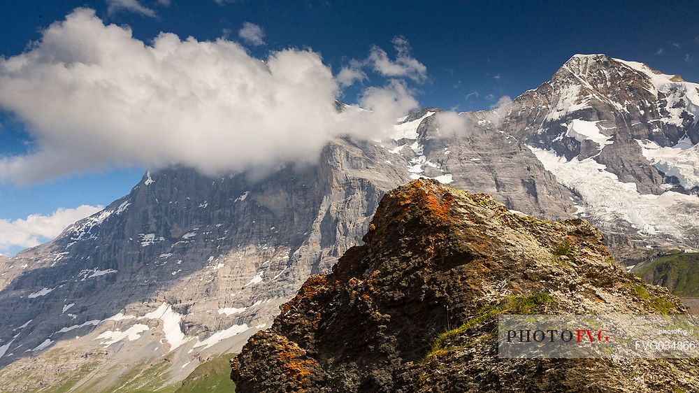 In front of the famous north face of Eiger mount in the clouds and the Jungfrau mountain group, Mannlichen, Grindelwald, Berner Oberland, Switzerland, Europe
 