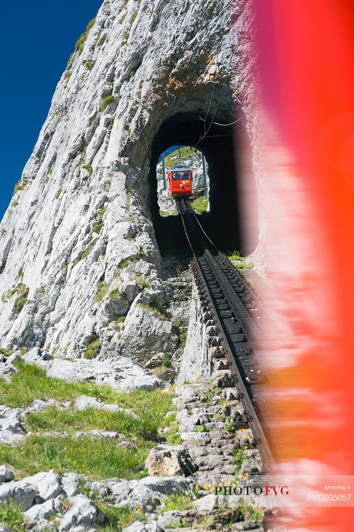The red Cogwheel Railway going up Pilatus Mountain, Border Area between the Cantons of Lucerne, Nidwalden and Obwalden, Switzerland, Europe