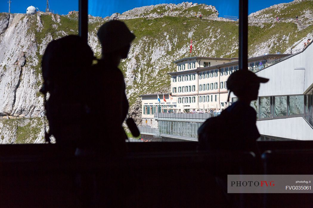 Tourists silhouette at the summit station of Pilatus Cogwheel Railway , Lucerne, Border Area between the Cantons of Lucerne, Nidwalden and Obwalden, Switzerland, Europe